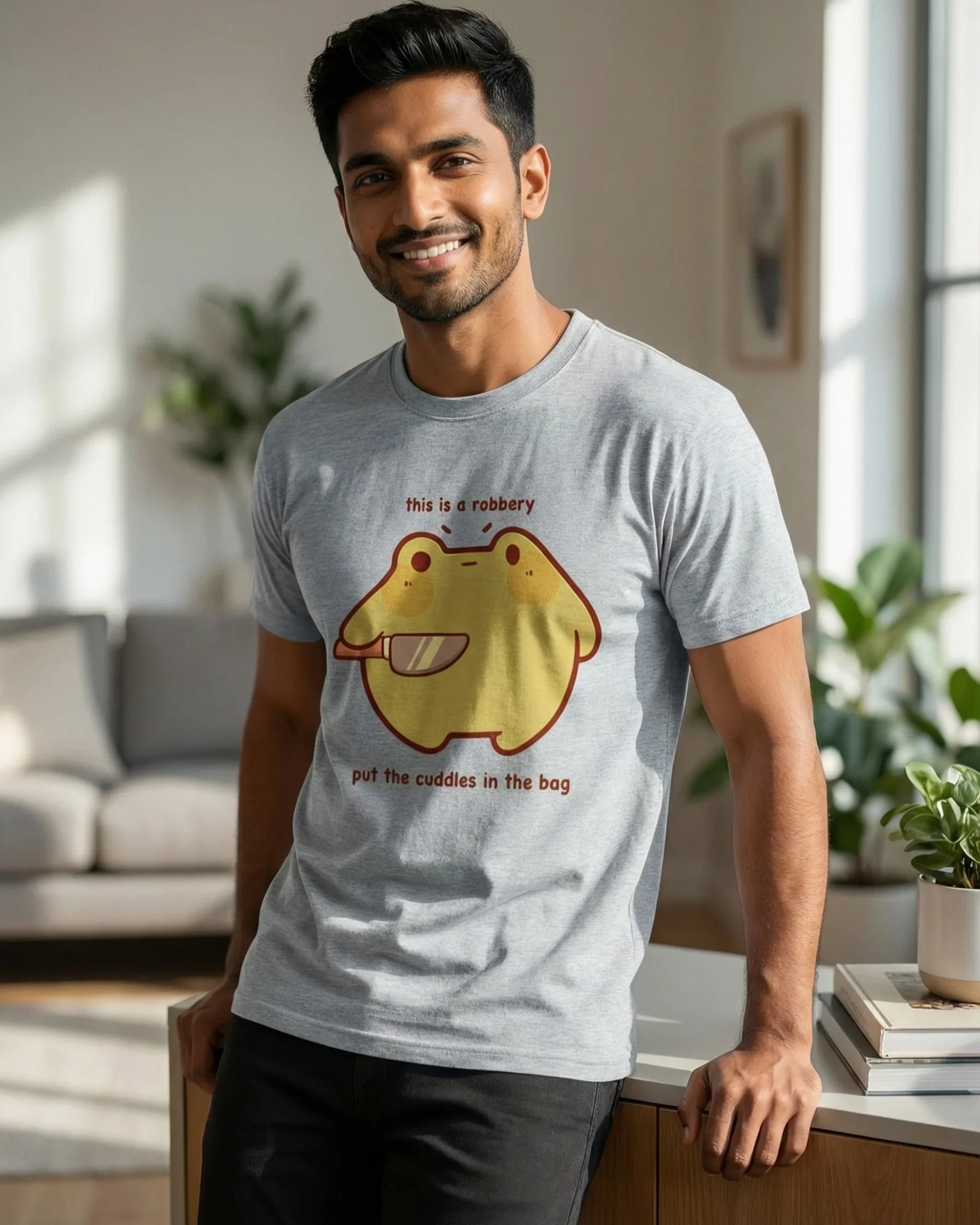 Man wearing gray melange t-shirt with cute cartoon print in bright, modern room